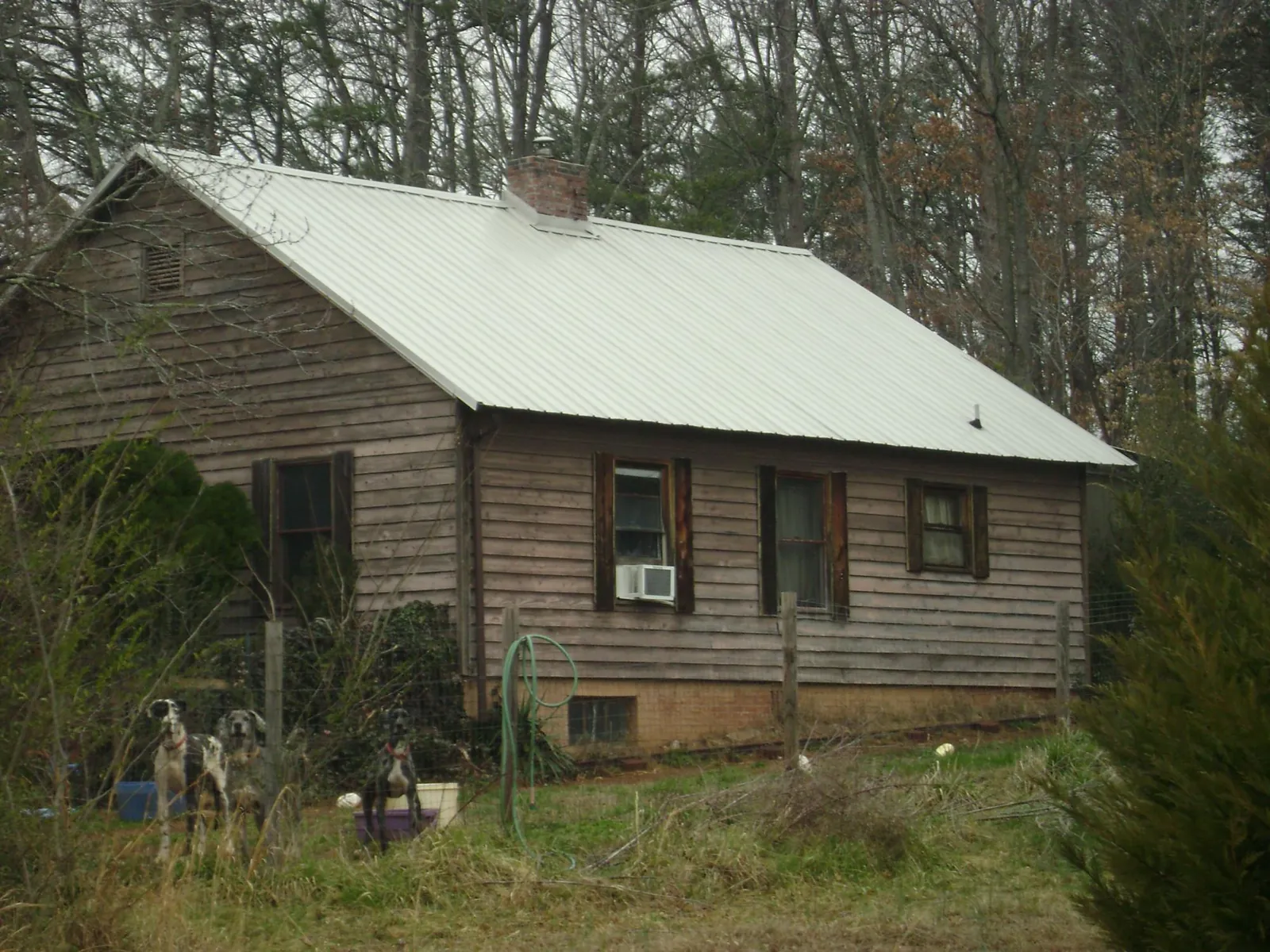 White metal roof on an old wood sided farmhouse, from a Metal Roof Installation job in South Otselic
